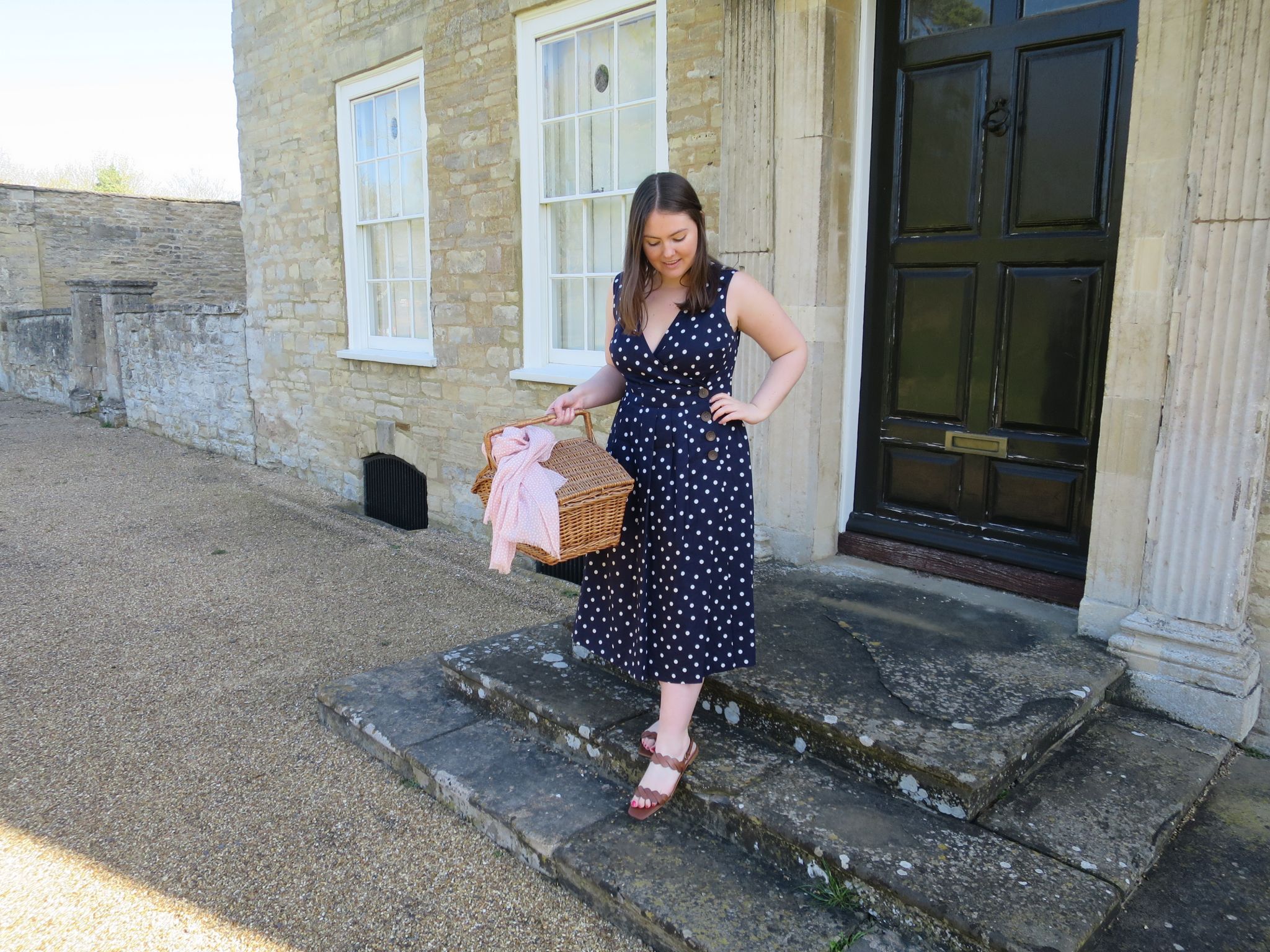 Navy and white polka dot Boden dress - standing on the doorstep of a big country house